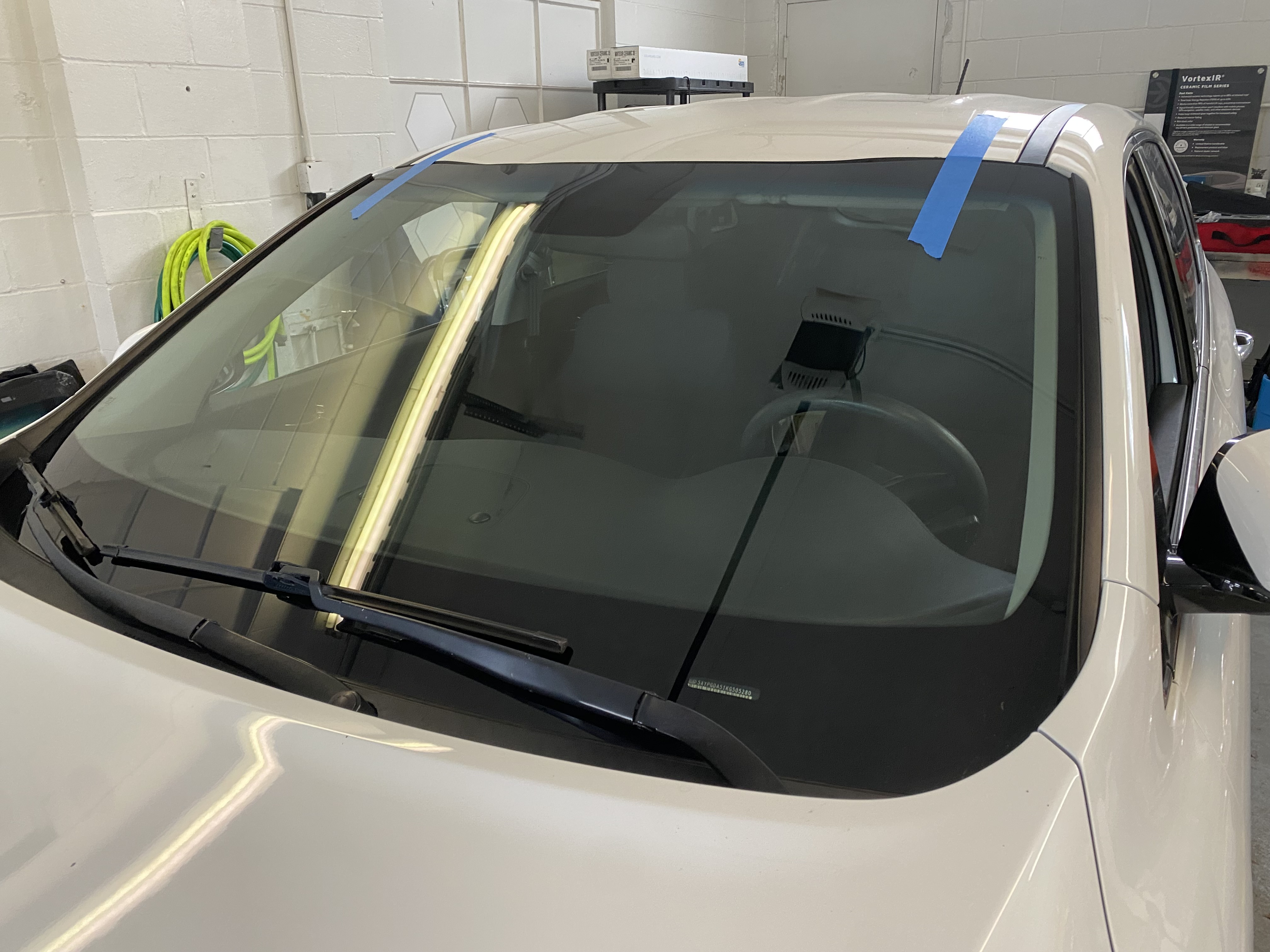 In-shop windshield replacement on white vehicle by Chip Doctor of Sioux Falls